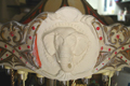 Carrousel musical en biscuit peint, XXème siècle, réfection d'un macaron éléphant pendant restauration
